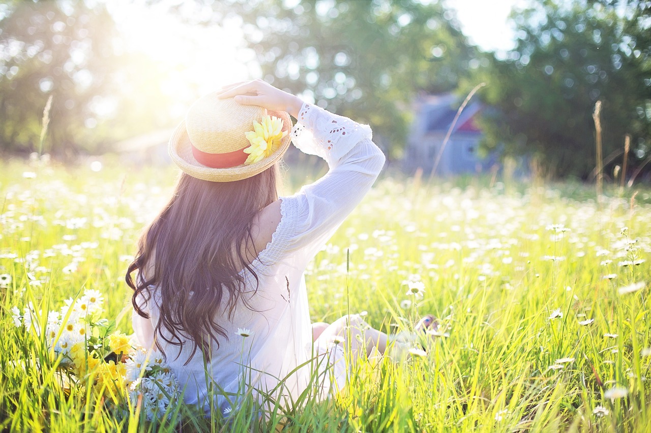 Image of a person sitting in nature, looking peaceful and serene